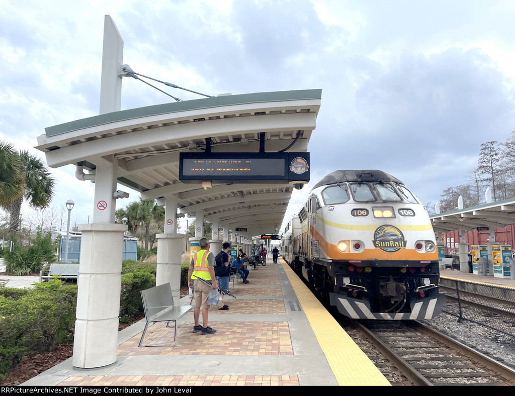 Northbound Sunrail Commuter Train # P324 arrives into Sand Lake Station behind MP32PH-Q # 106 on the point.